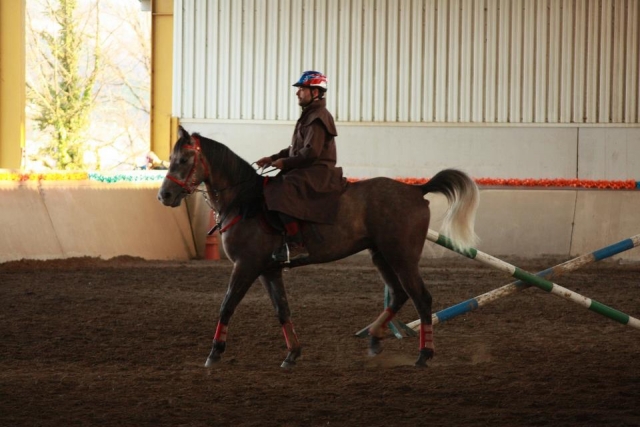  Man with raincoat riding a horse 